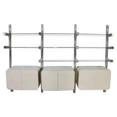 three white leather storage shelves with glass shelves