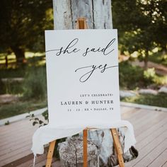 an easel with a sign that says she said yes on it and the words, let's celebrate lauren & hunter