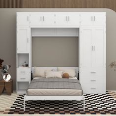 a white bed sitting under a tall white cabinet