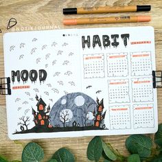 a calendar with the word habitt written on it next to leaves and pencils