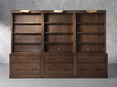 an empty bookcase with drawers and lights