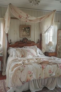 a bed sitting in a bedroom next to a window with curtains on the top of it