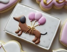 decorated cookies in the shape of dogs and balloons