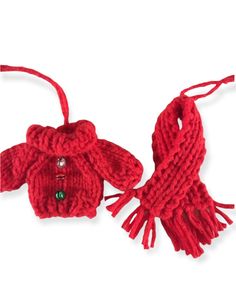 a red knitted ornament hanging from a string