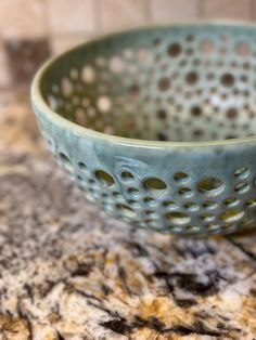 a blue bowl sitting on top of a counter