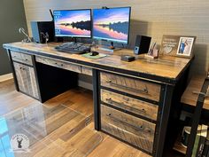 two computer monitors sitting on top of a wooden desk next to a keyboard and mouse