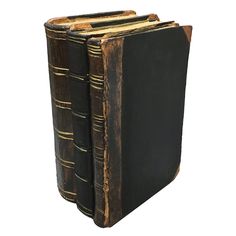 two old books are sitting side by side on a white background, one is black and the other is brown