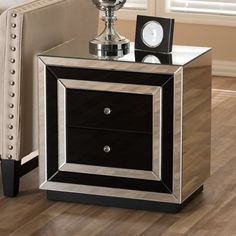 a black and silver nightstand with a clock on top