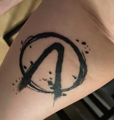 a person with a peace sign tattoo on their arm