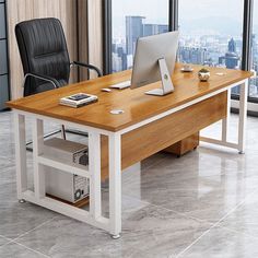 an office desk with a laptop on it and a chair in front of the window