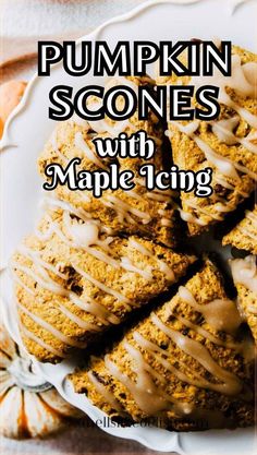 pumpkin scones with maple icing on a white plate