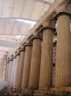 some very tall pillars in a big building