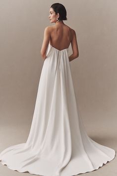 the back of a woman's white wedding dress, with an open - back