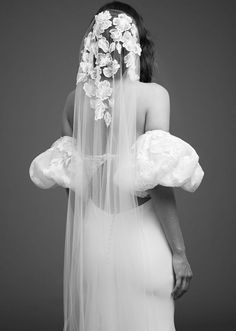 a woman wearing a veil with flowers on it