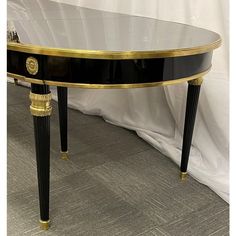 a black and gold console table with glass top