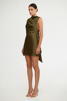 Our best selling Lana Dress has been reimagined for the event season ~ The Annabel Bias Mini Dress in Olive is an elegant silhouette. Featuring soft draping detail through the body and open back feature with adjustable back ties. A great option for bridesmaids. PRODUCT DETAILS - Mini dress - Unlined - Back bodice ties - Invisible back zipModel is 180cm / 5'10″ wearing an AU 8 / US 4 Composition: Main: 62% Viscose Rayon, 38% Polyester Lining: 97% Polyester, 3% Elastane CARE INSTRUCTIONS This fabr Lana Dress, Viscose Rayon, Delicate Design, Slow Fashion, Modern Woman, Open Back, Bodice, Care Instructions