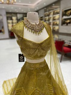 Elevate your bridal look with our Metallic Yellow Bridal Lehenga BL-121! The stunning metallic yellow color, beautifully complemented by intricate foil work, will make you stand out on your special day. Make a bold statement and feel like a princess with this breathtaking lehenga! Fabric: Net with Raw Silk Lining! WASH CARE INSTRUCTIONS - Please Dry clean only when it is applicable! Ready to Ship! Gold Floor-length Anarkali Set With Cutdana, Gold Sharara With Gold Embroidery For Reception, Elegant Pista Green Lehenga With Cutdana, Gold Choli For Reception, Gold Bollywood Choli For Reception, Gold Kundan Lehenga For Reception, Pista Green Anarkali Set With Unstitched Blouse For Wedding, Gold Semi-stitched Kundan Lehenga, Gold Kundan Sharara For Reception