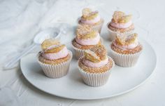 small cupcakes with frosting and sprinkles on a white plate