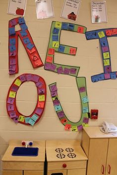 a classroom wall with several pieces of paper cut out to spell out the word's