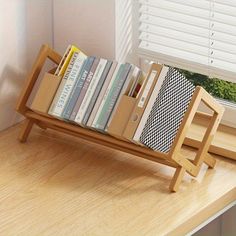 a bookshelf filled with lots of books next to a window