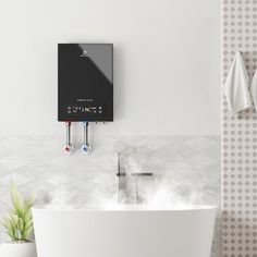 a white bath tub sitting in a bathroom next to a wall mounted heater and towel dispenser