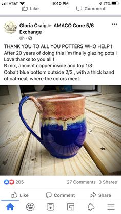 a blue and brown mug sitting on top of a wooden table