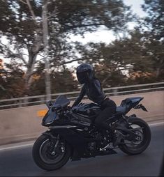 a person riding on the back of a black motorcycle