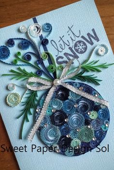 a card made with buttons and paper flowers