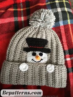 a knitted hat with a snowman on it