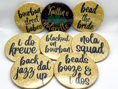 six gold glittered badges with black writing on them