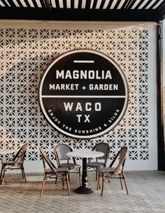 the sign for magnalia market and garden waco tx in front of some chairs