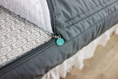 a close up of a bed with a zipper on it