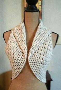 a mannequin wearing a white crocheted vest