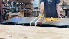 a man is working on a table sawing