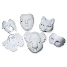 white masks with faces on them are arranged in the shape of an elephant and a cat