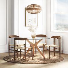 a dining room table with chairs and a round rug on the floor in front of it