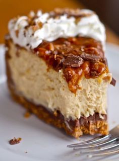 a piece of cheesecake with whipped cream and chocolate toppings on a white plate