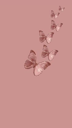 three pink butterflies flying in the air