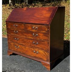 an old chest of drawers is sitting on the pavement