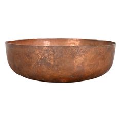 a large metal bowl sitting on top of a white surface with no one in it