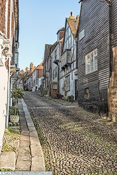 an old cobblestone street lined with wooden buildings