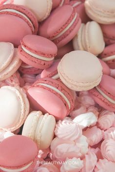 pink and white macaroons are scattered together