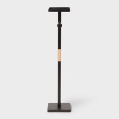 a black metal pole with a wooden stick sticking out of it's centerpiece