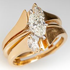 This pretty two ring wedding set consists of a diamond solitaire style engagement and a diamond guard style ring. The engagement ring contains one (1) marquise brilliant cut diamond set into a six-prong head. The guard ring is accented with two (2), prong set, marquise brilliant cut diamonds. The set measures 13.1mm at the top, rises 5.9mm above the finger, tapering to 4.9mm wide and 1.2mm thick at the base of the shanks. This ring is currently a size 4. Diamond White Marquise Cut Diamond Marriage Ring, Marquise Cut Diamond White Diamond Ring For Marriage, Marquise Cut Diamond White Marriage Ring, Marquise Tension Setting Formal Jewelry, Marquise Tension Setting Fine Jewelry, Wedding Ring With Marquise Cut Single Diamond, Formal Marquise Tension Setting Wedding Jewelry, Marquise Cut Single Diamond Wedding Ring, Marquise Cut Diamond White Bridal Sets For Formal Occasions