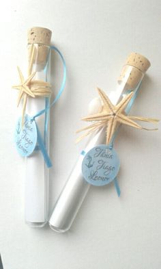 two wine bottles wrapped in twine and tied with blue ribbon, sitting next to each other