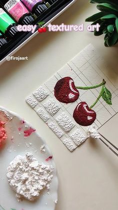 a white plate topped with cake next to a painting