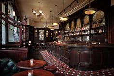 a dimly lit bar with lots of stools