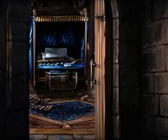 an open door leading into a dark room with a bed and desk in the doorway