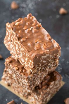 three pieces of chocolate peanut butter bars stacked on top of each other