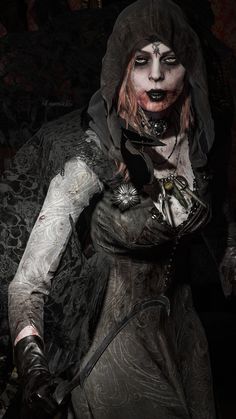 a woman dressed as a zombie holding a knife